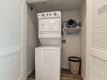 A small laundry room with a washer and dryer.
